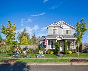 Family of three riding bikes in Lacey neighborhood